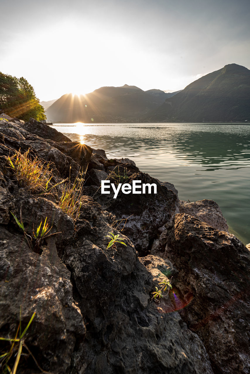 Scenic view of lake and mountains against sky