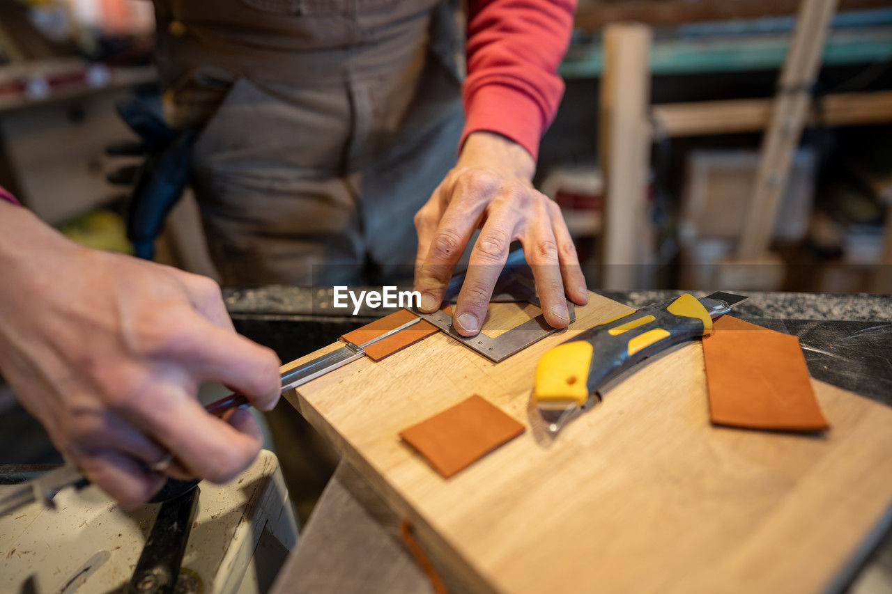 midsection of man working at table