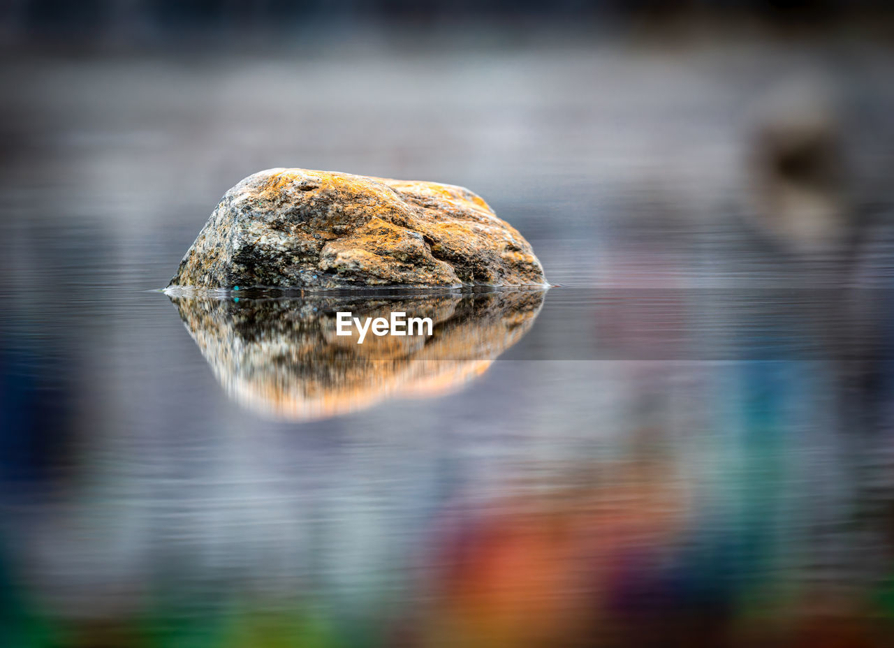 CLOSE-UP OF REFLECTION OF ROCK IN WATER