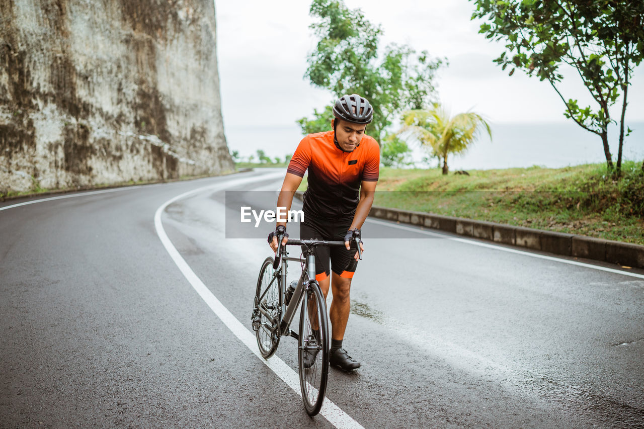 Man riding bicycle on road