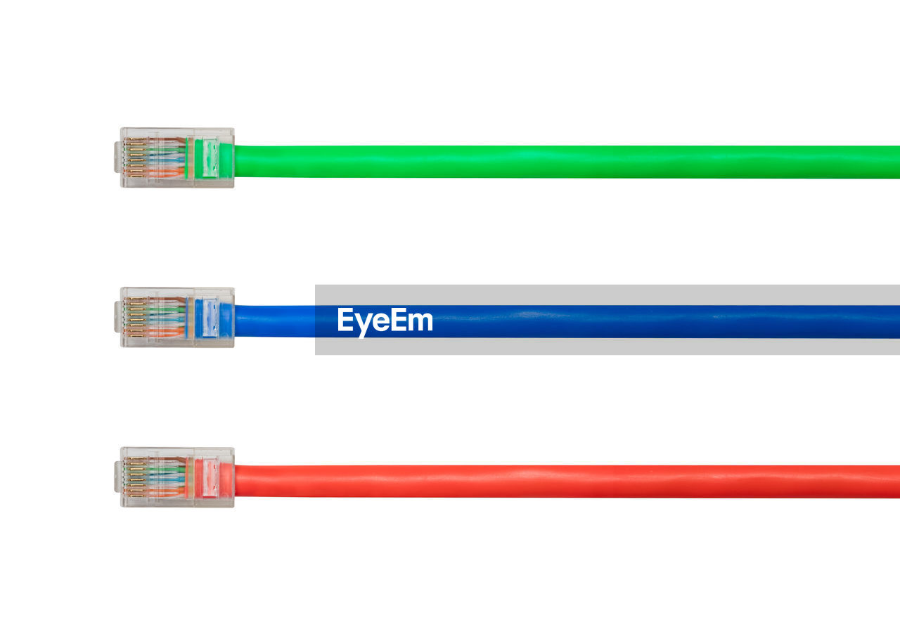 Close-up of network connection plugs against white background