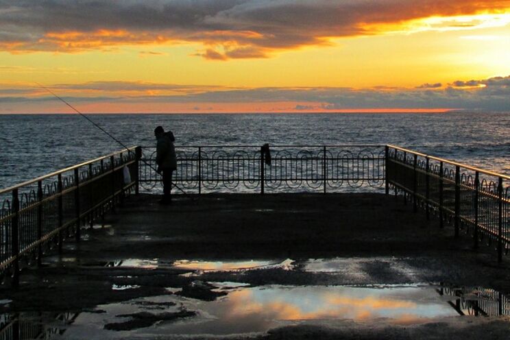 SILHOUETTE OF PIER AT SUNSET