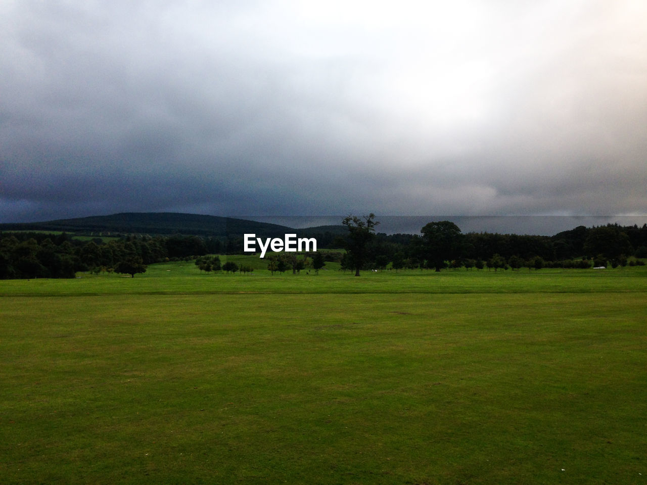 SCENIC VIEW OF GREEN LANDSCAPE AND SKY