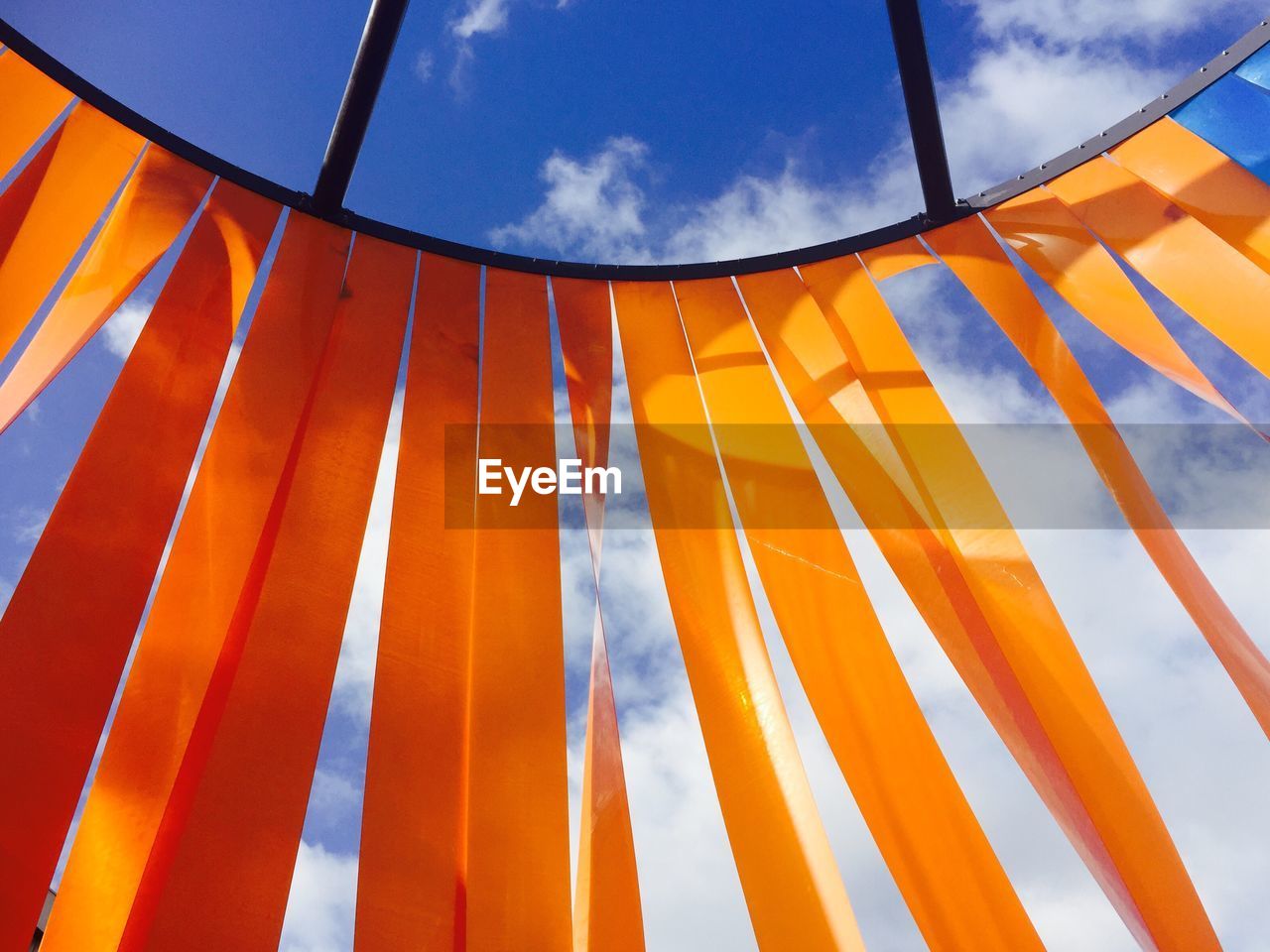 Low angle view of decoration hanging against blue sky