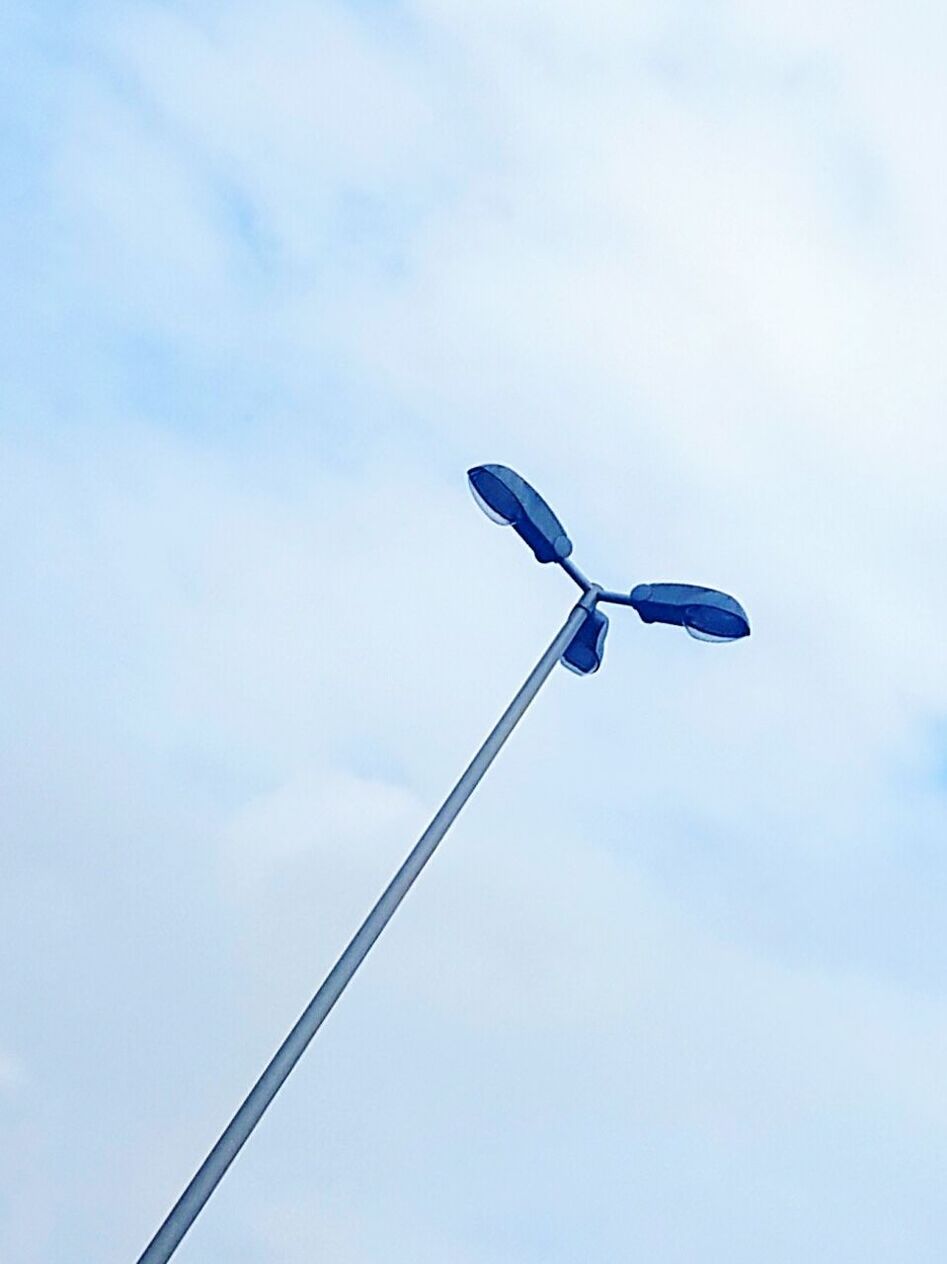 Tilt image of street lights against sky