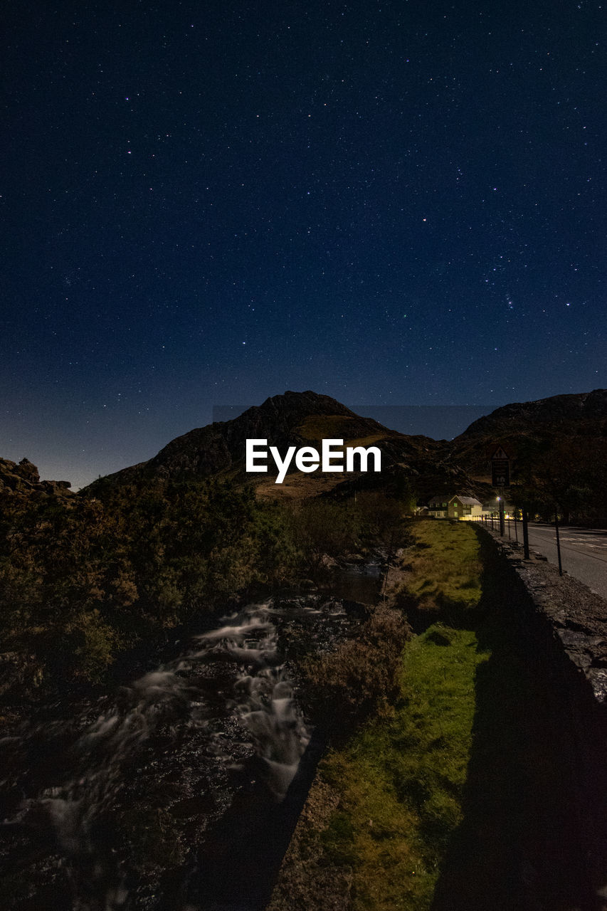 Scenic view of mountains against sky at night