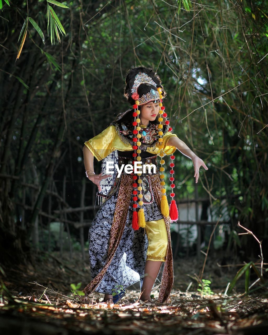 WOMAN STANDING IN FOREST