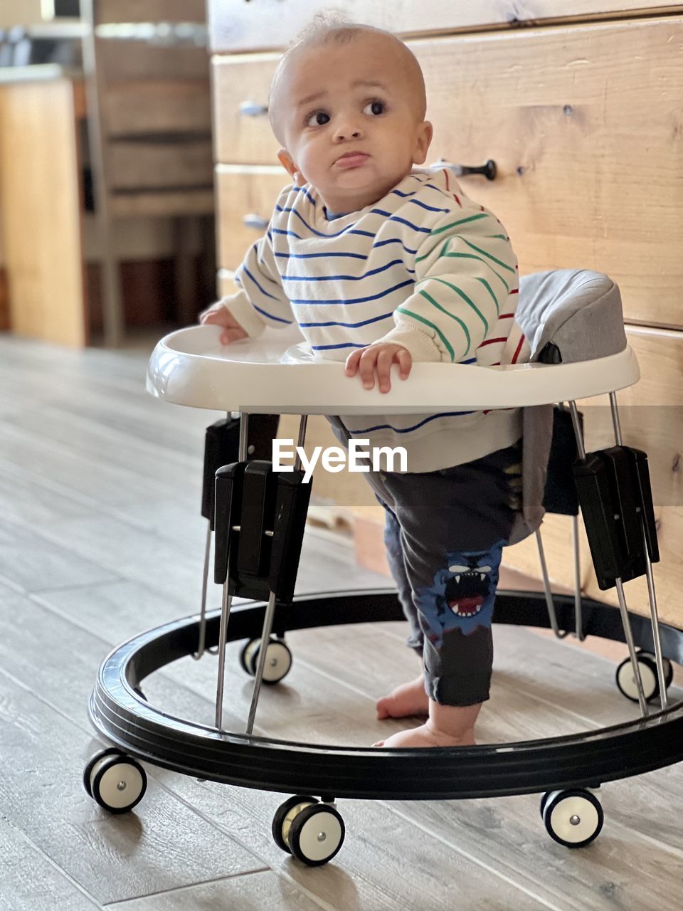 portrait of cute baby boy sitting on wheelchair