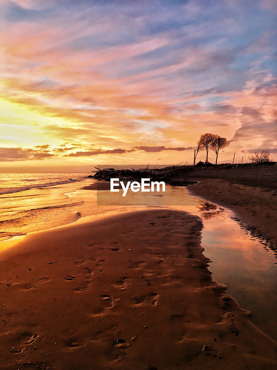 SCENIC VIEW OF BEACH DURING SUNSET