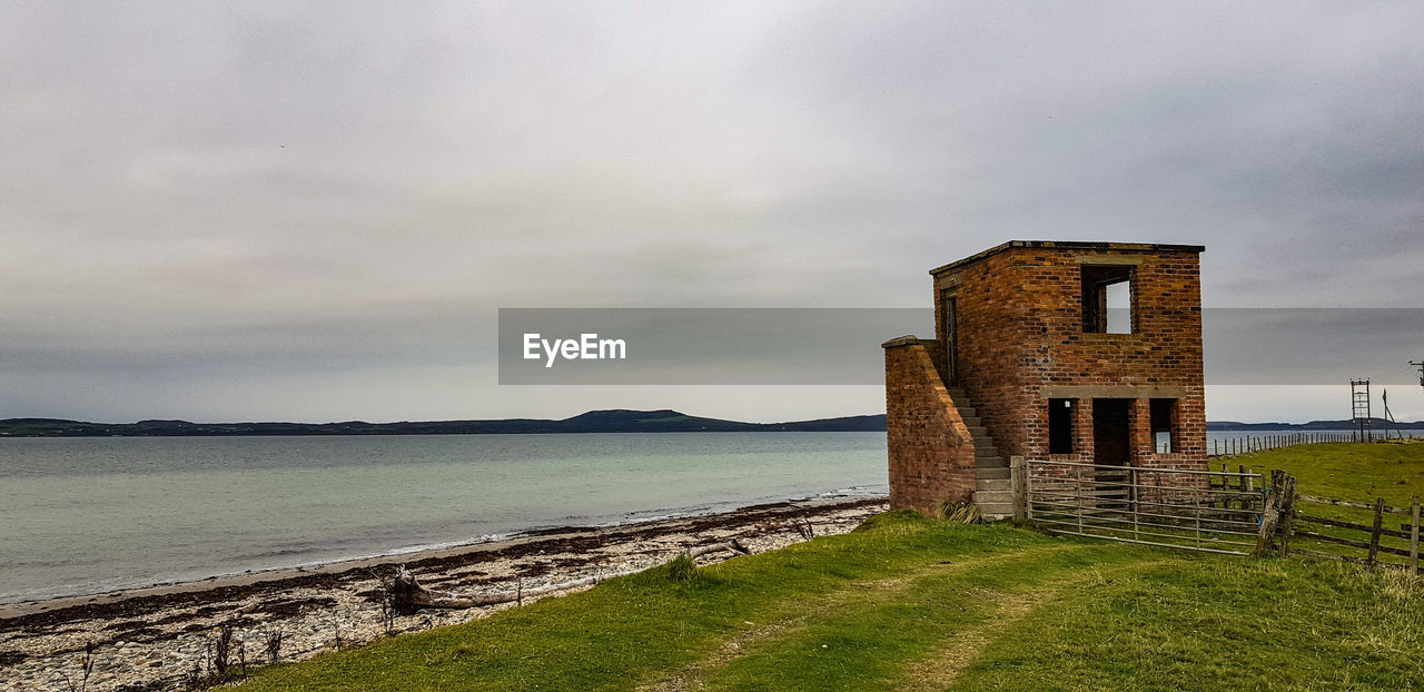 CASTLE BY SEA AGAINST SKY