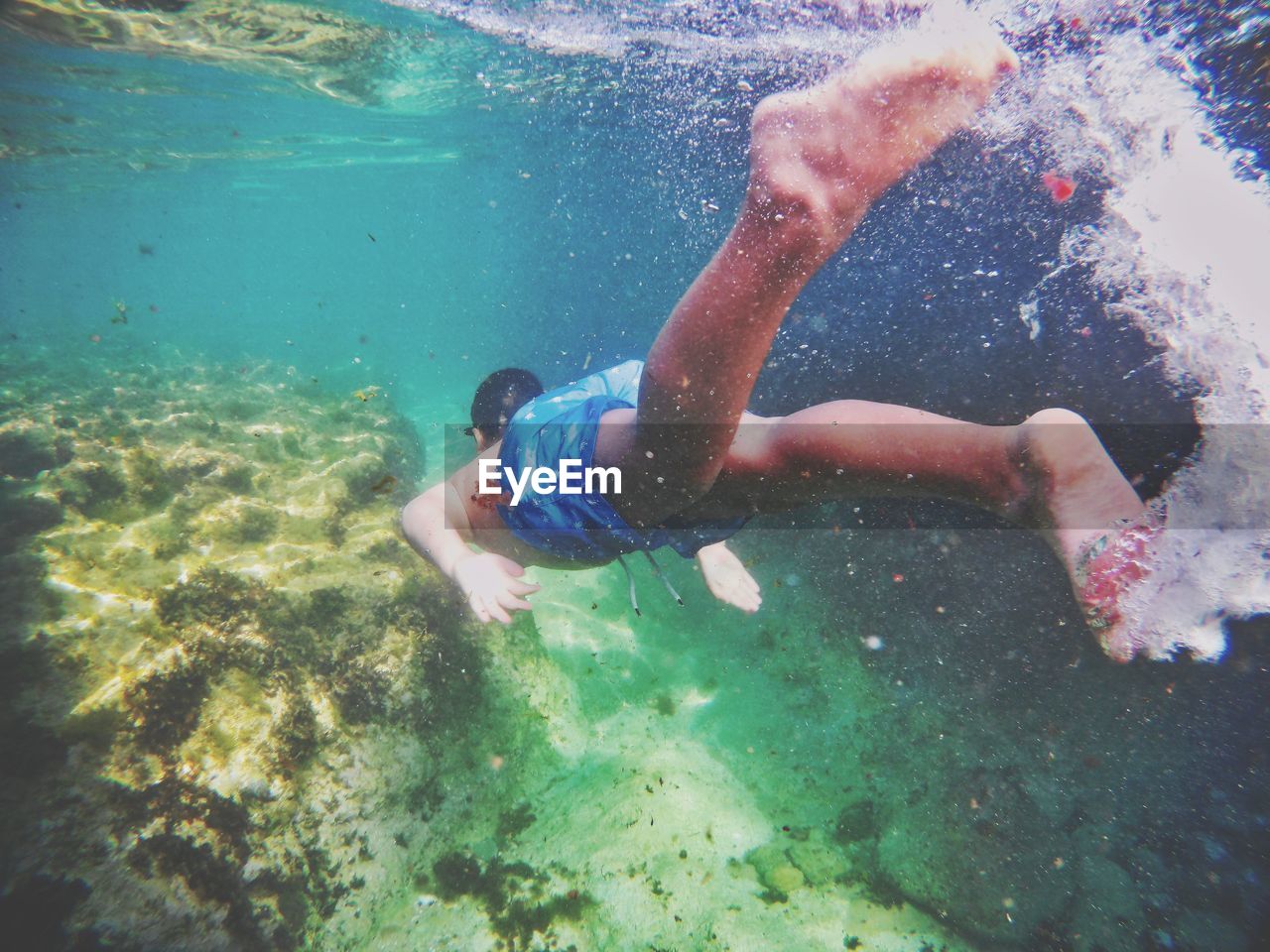 High angle view of boy swimming in sea