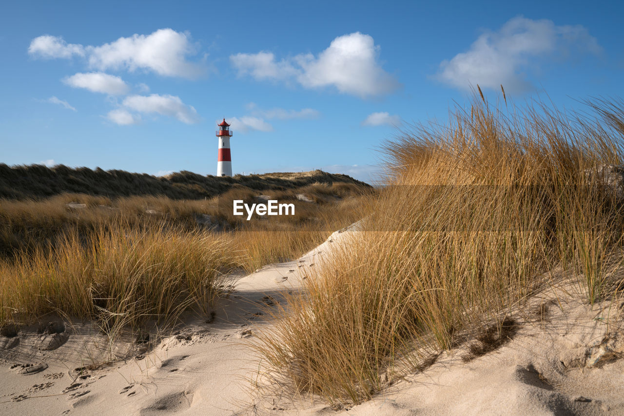 Panoramic image of list east lighthouse against blue sky, sylt, north frisia, germany