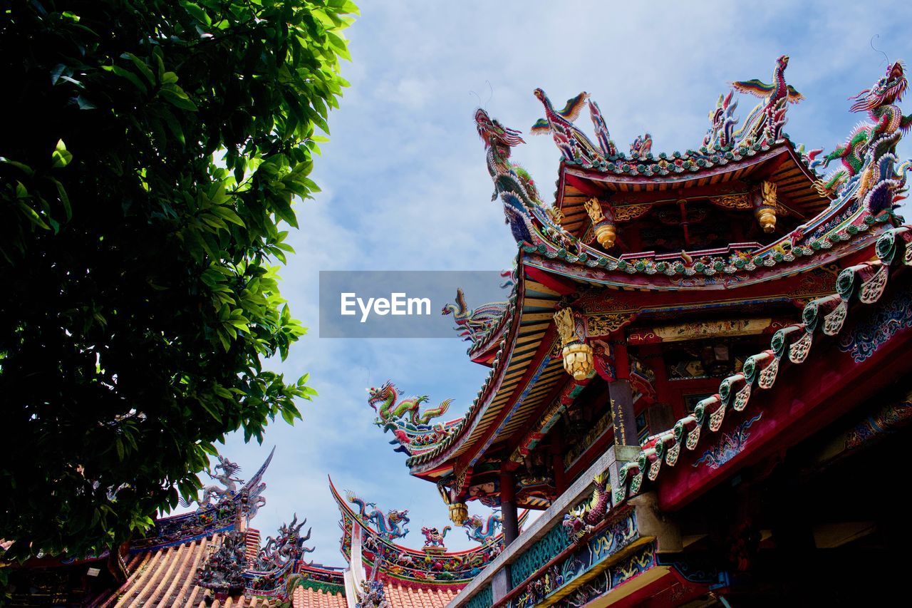 LOW ANGLE VIEW OF TRADITIONAL TEMPLE AGAINST SKY