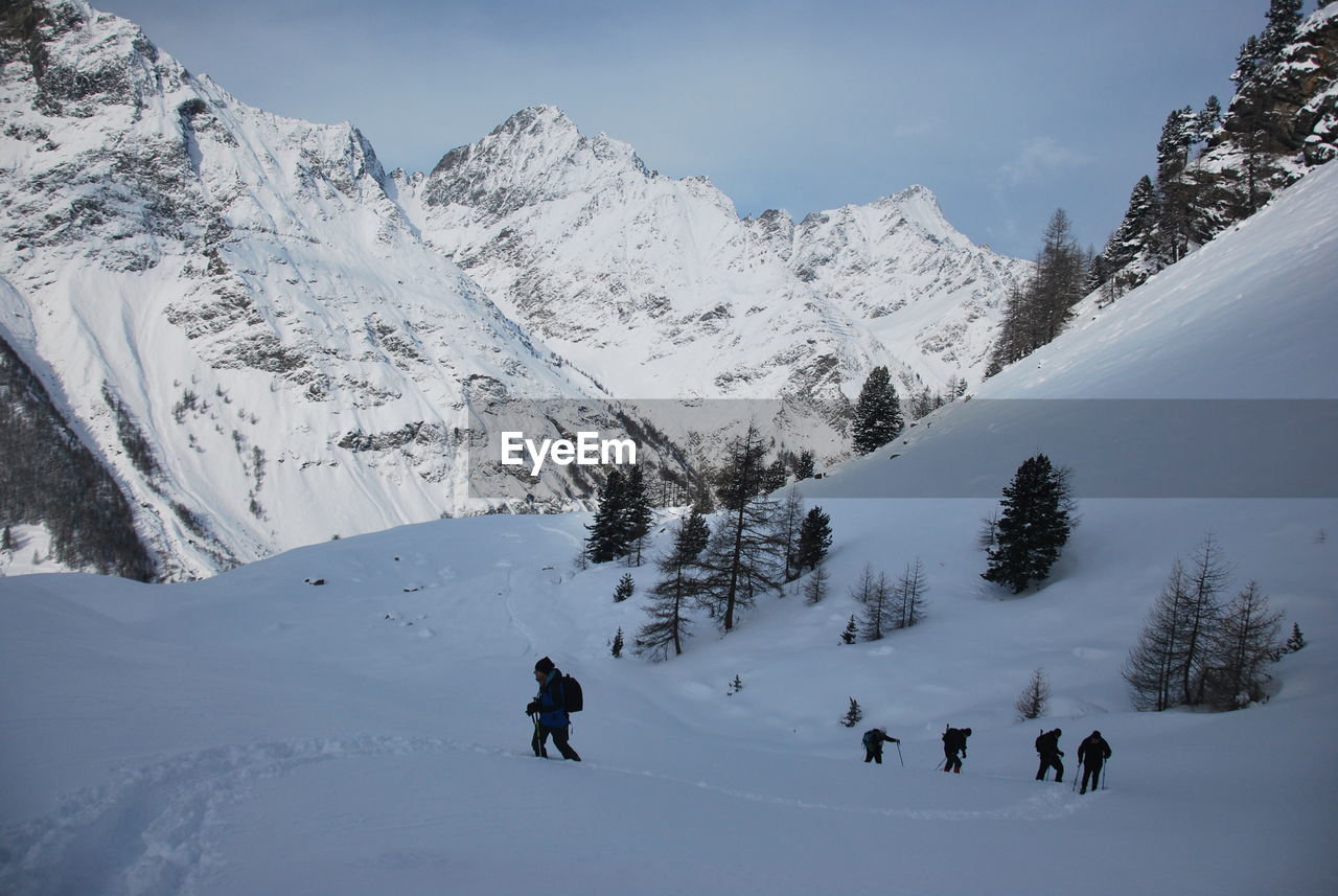 People on snow covered mountain during winter