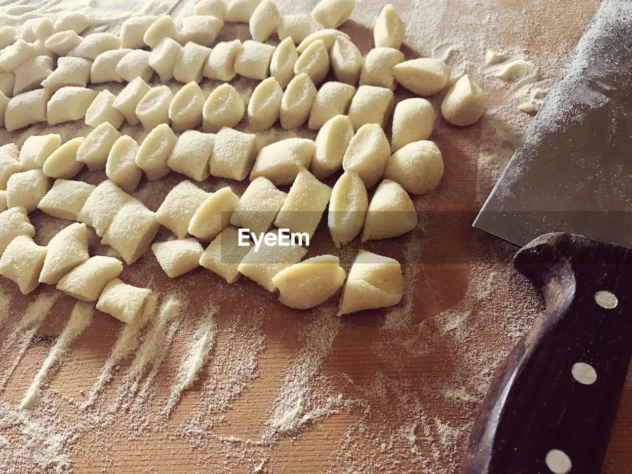 Close-up of raviolis by kitchen knife on cutting board