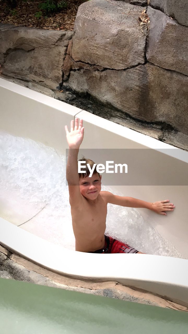 Full length of smiling boy in water