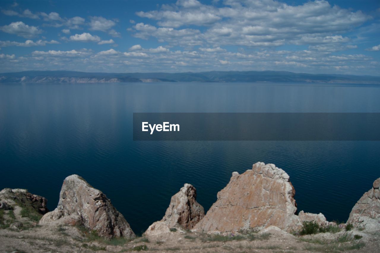 Scenic view of lake and mountains against sky