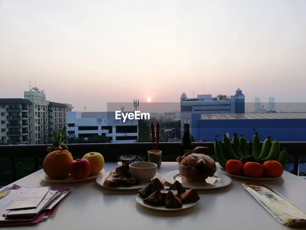 FOOD ON TABLE AGAINST SKY IN CITY