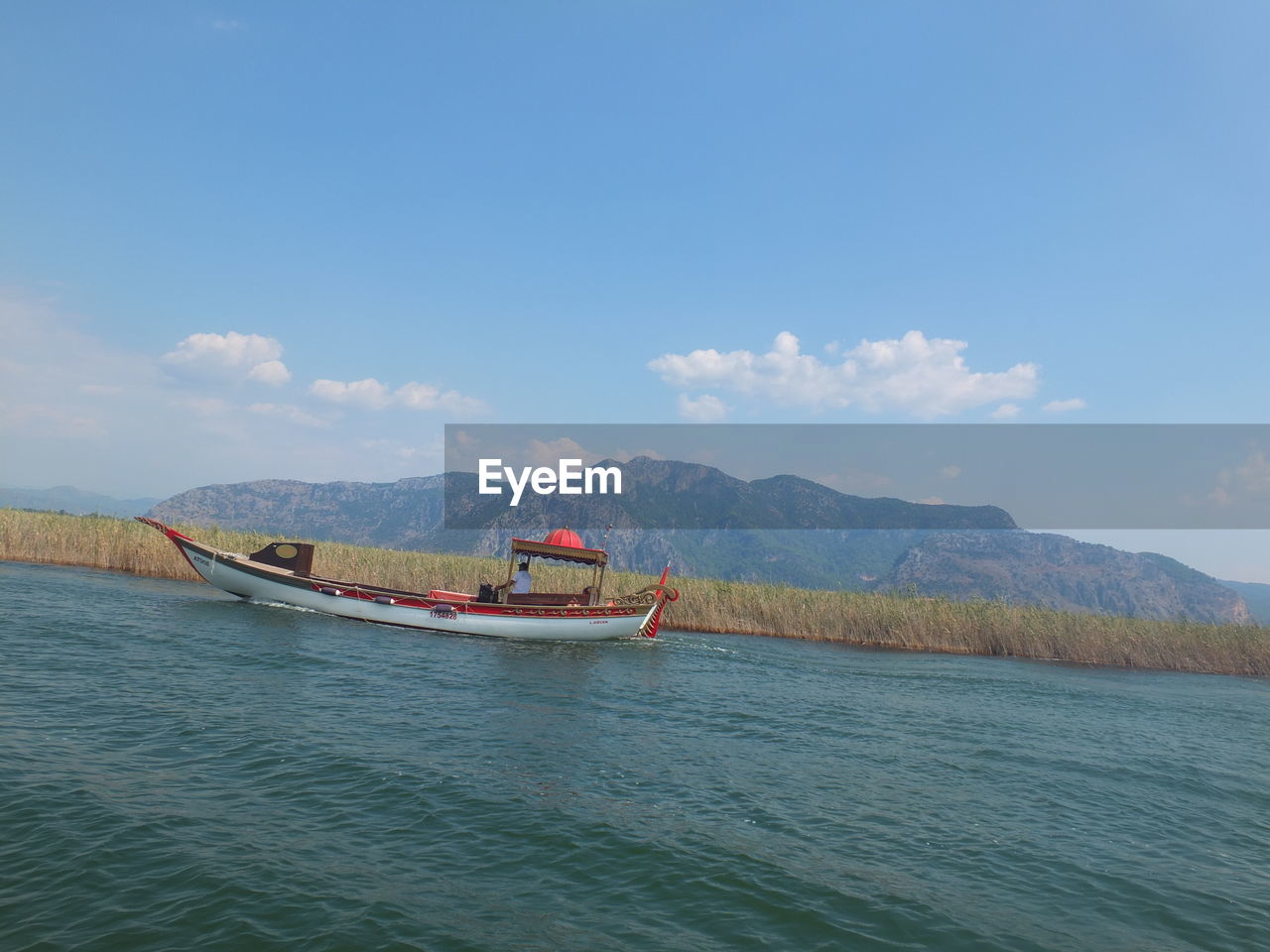 BOAT IN SEA AGAINST SKY