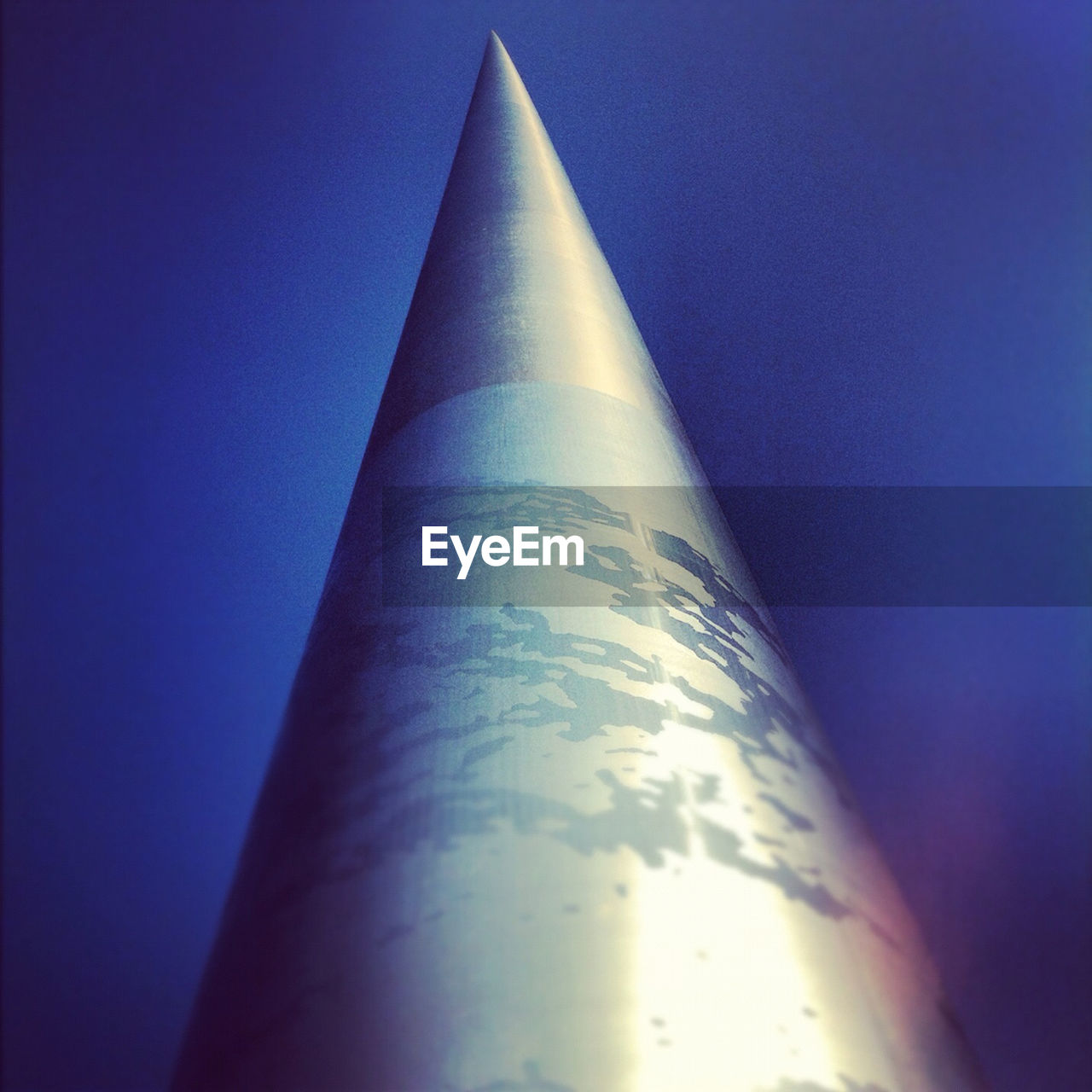 Low angle view of monument of light against clear blue sky