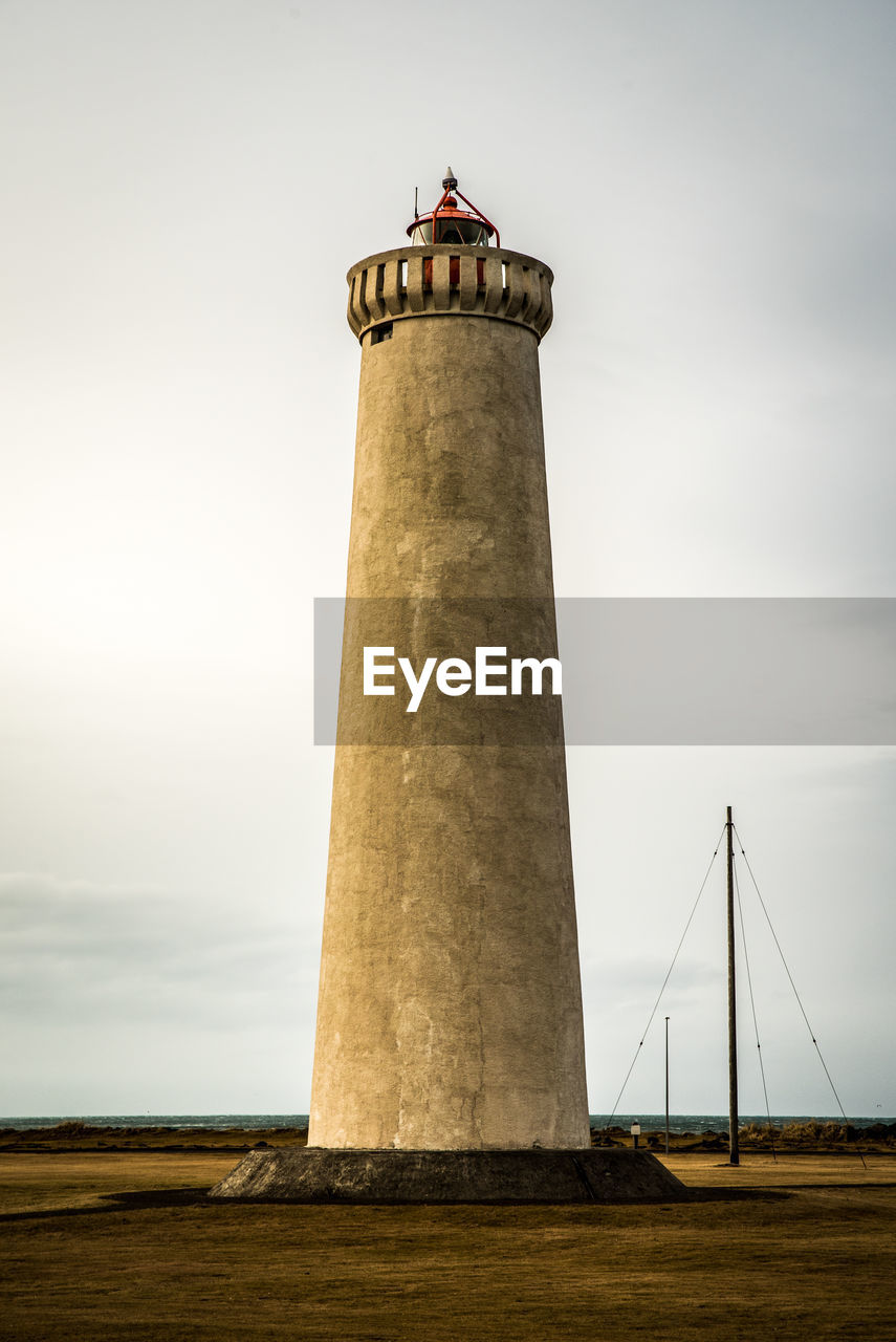 LIGHTHOUSE IN SEA AGAINST SKY