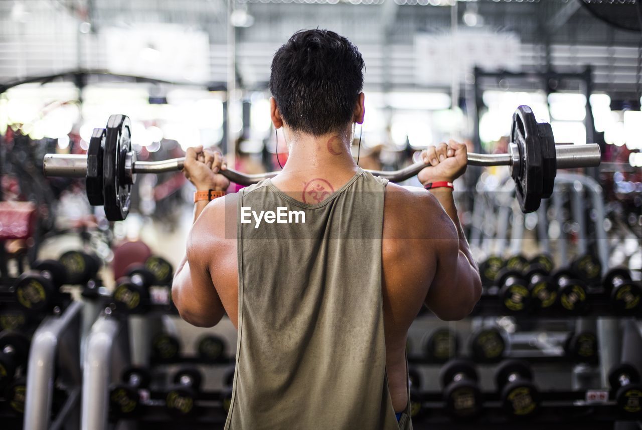 Rear view of man exercising at gym