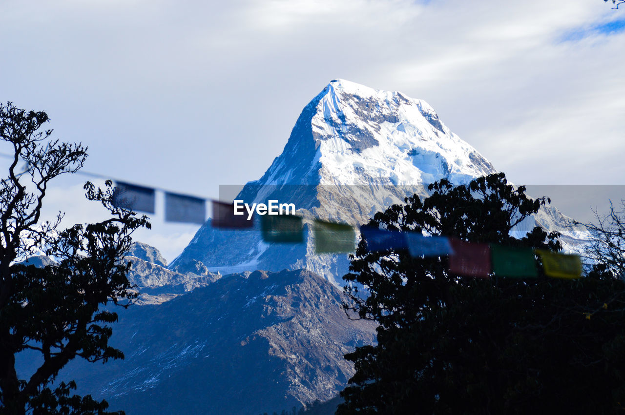 Prayer flags against mountains during winter