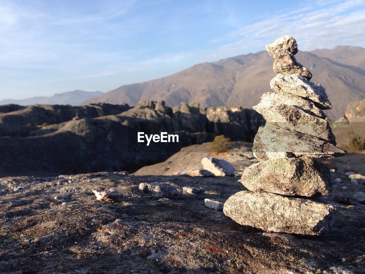 Close-up of stacked rocks against mountains