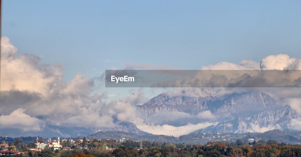 Panoramic shot of buildings and mountains against sky