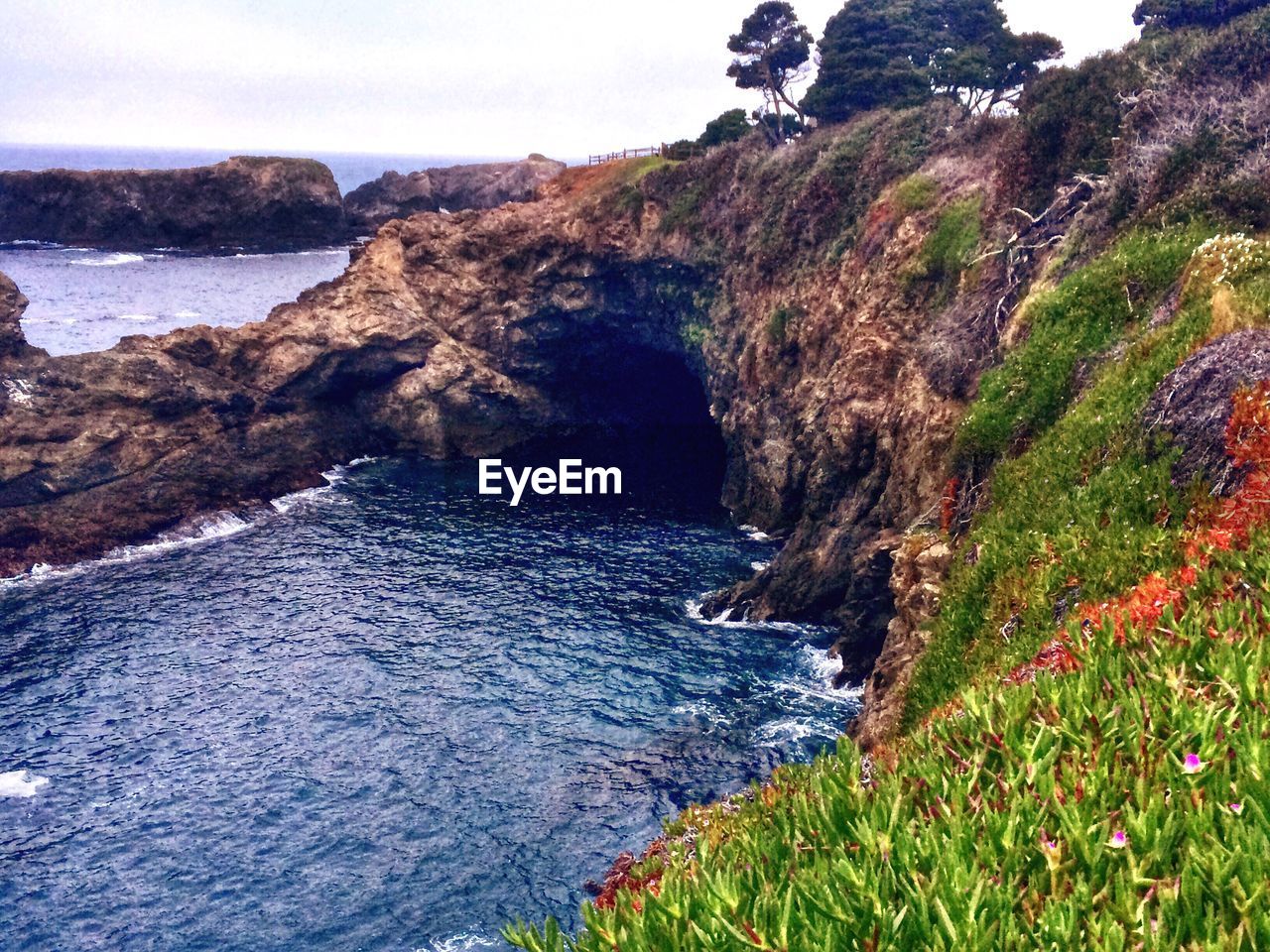 High angle view of sea by rock formations