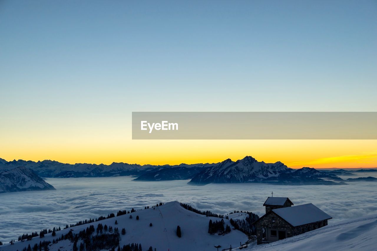 Scenic view of snow covered landscape against clear sky