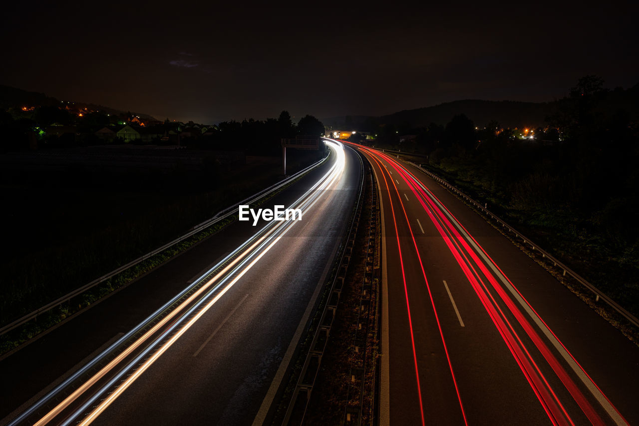 High angle view of light trails on highway at night