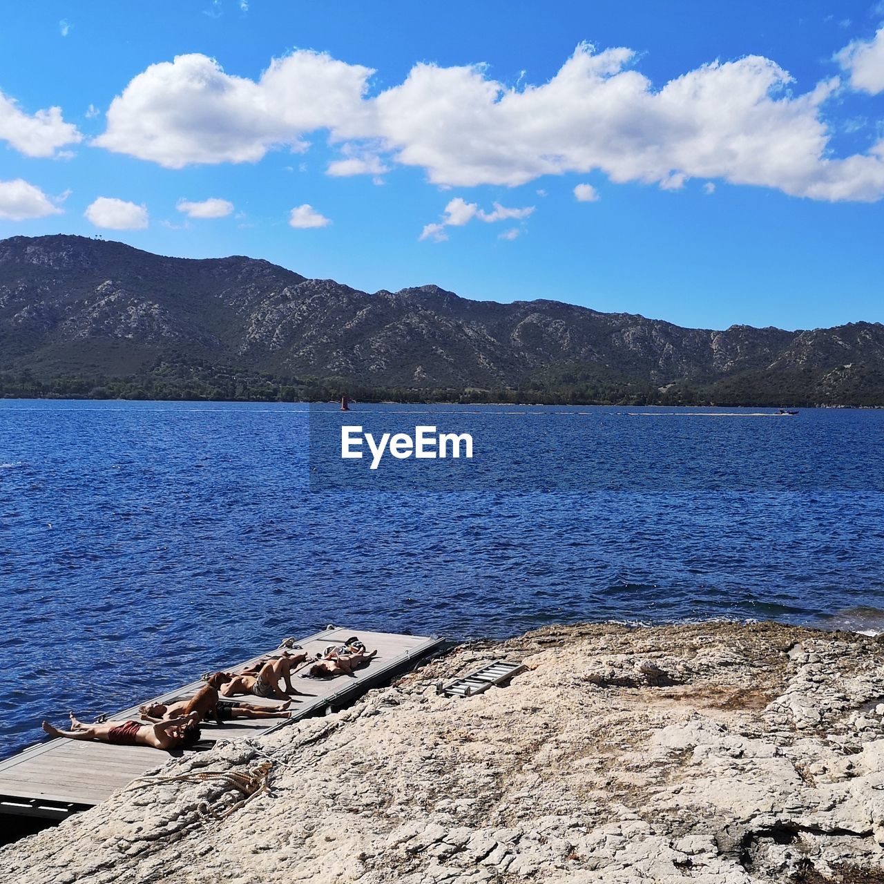 SCENIC VIEW OF LAKE AGAINST MOUNTAIN