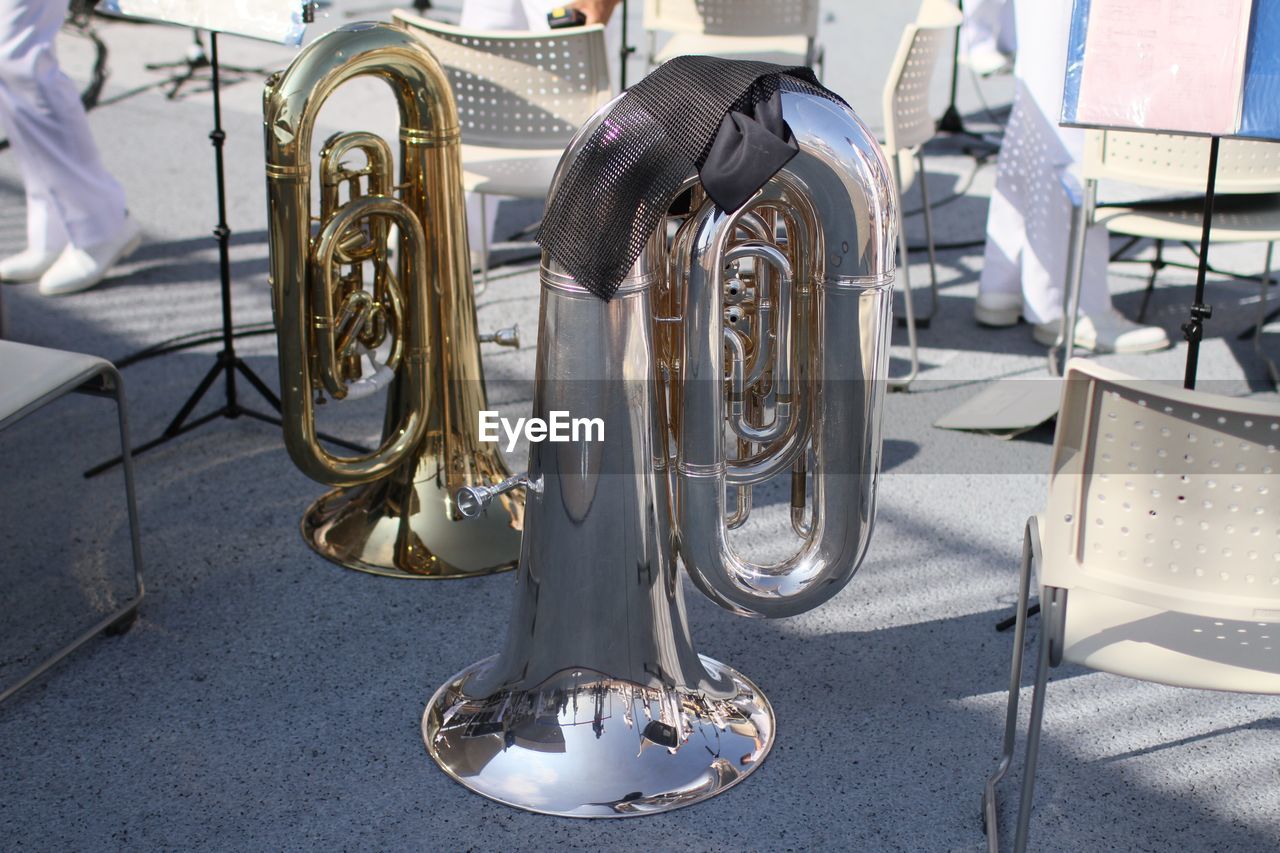 Tubas by chairs on street