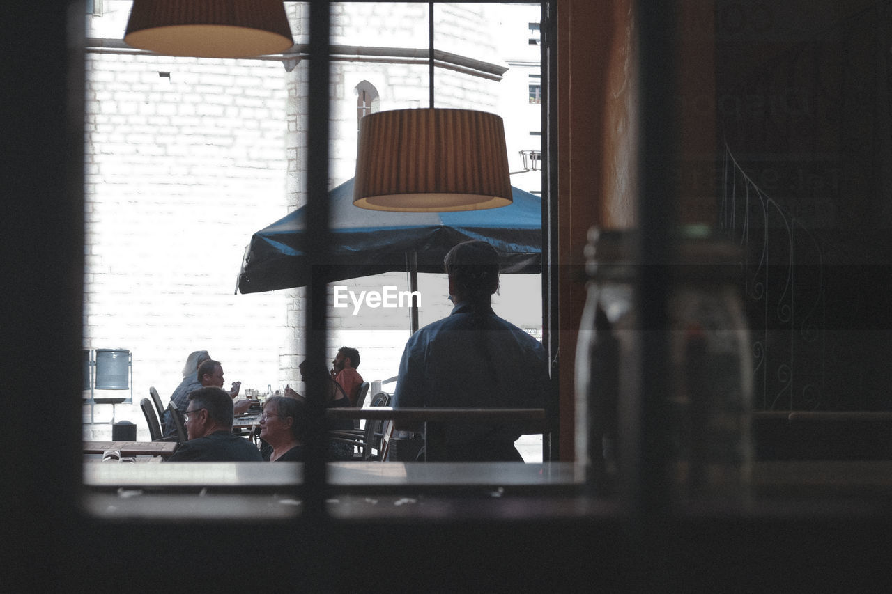 PEOPLE SITTING AT RESTAURANT