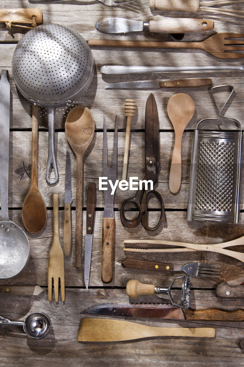 Various kitchen utensils hanging on wood