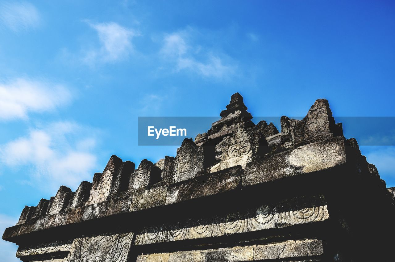 High section of built structure against blue sky