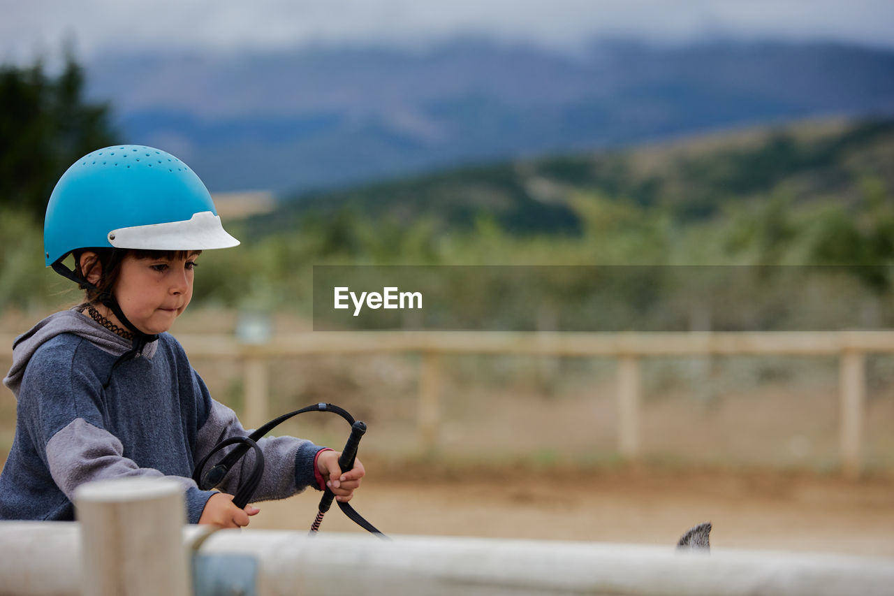 5 year old girl riding a horse with lovely expression