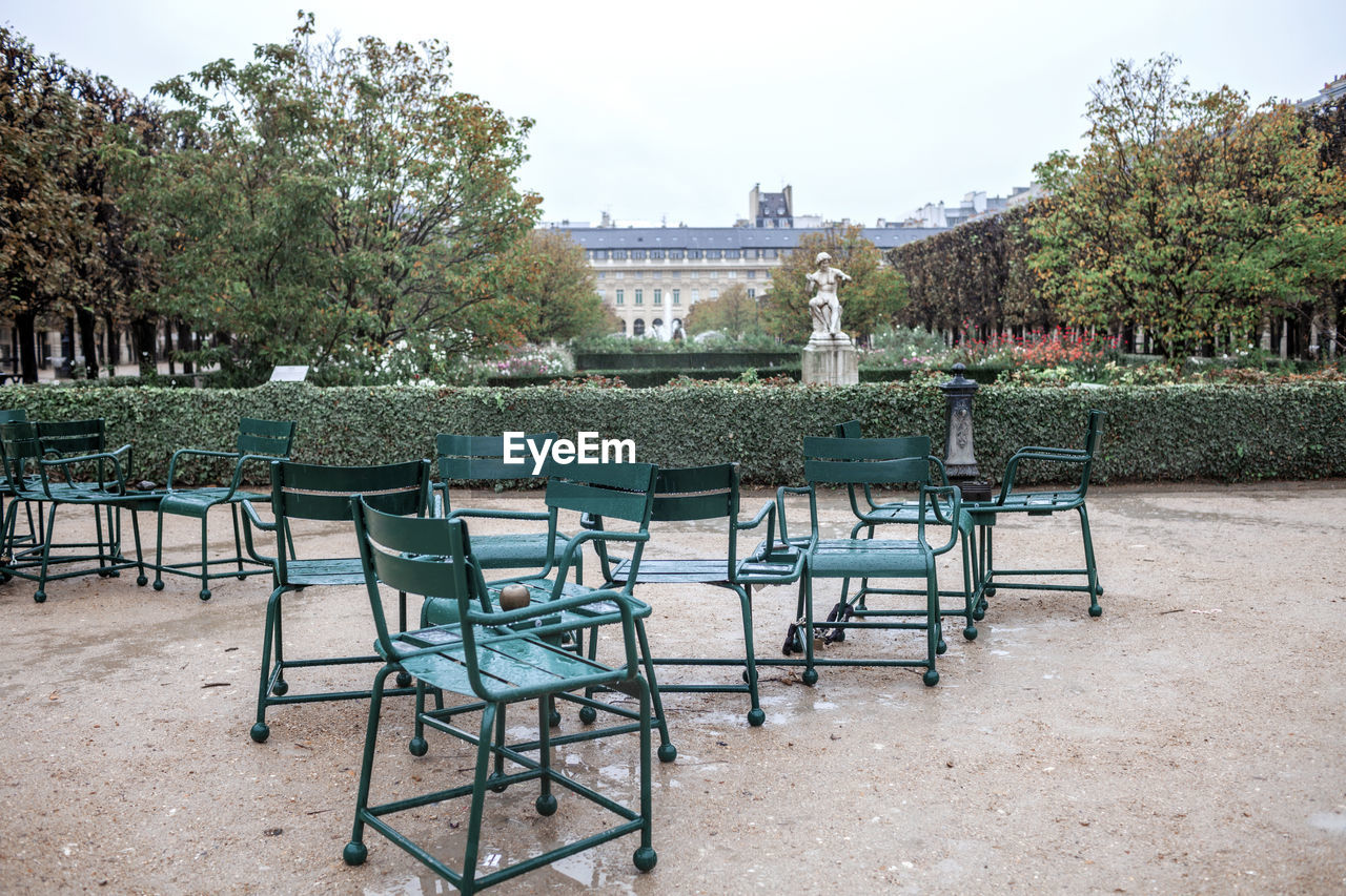 seat, chair, architecture, tree, plant, nature, table, sky, built structure, travel destinations, no people, empty, outdoors, absence, day, city, estate, building exterior, furniture, building, travel, tourism, cafe, land, food and drink, water