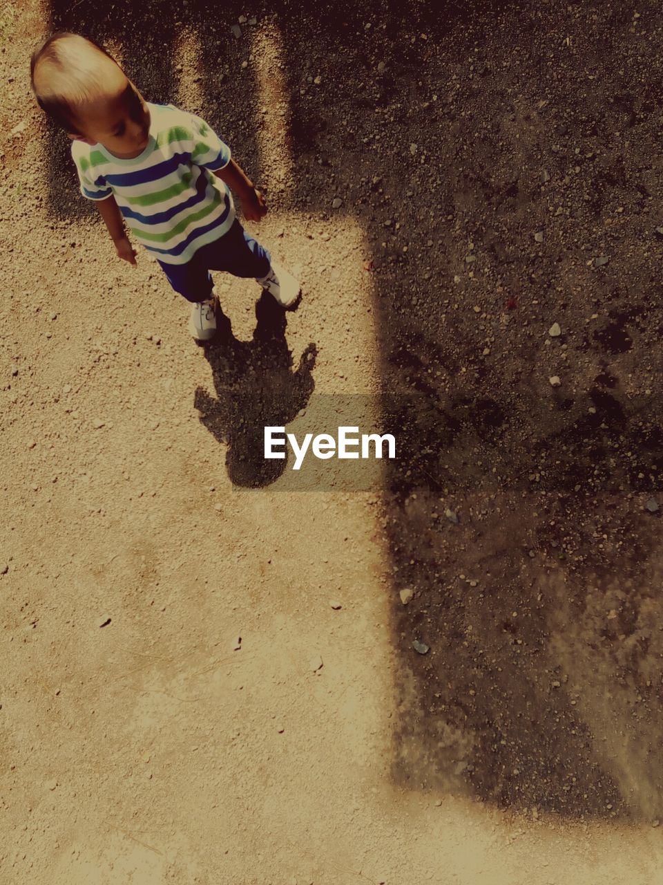 High angle view of boy standing on field