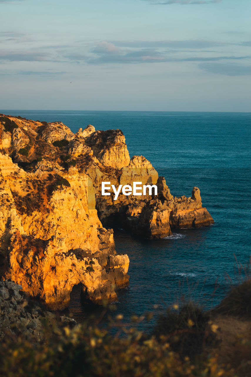 Scenic view of cliff against sea and sky