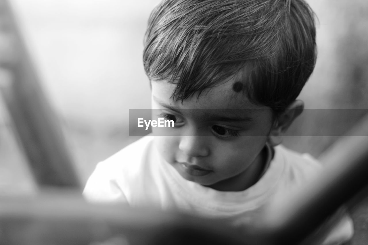 Close-up of cute boy looking away