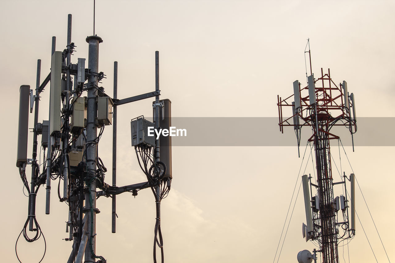 Low angle view of electricity pylon against sky