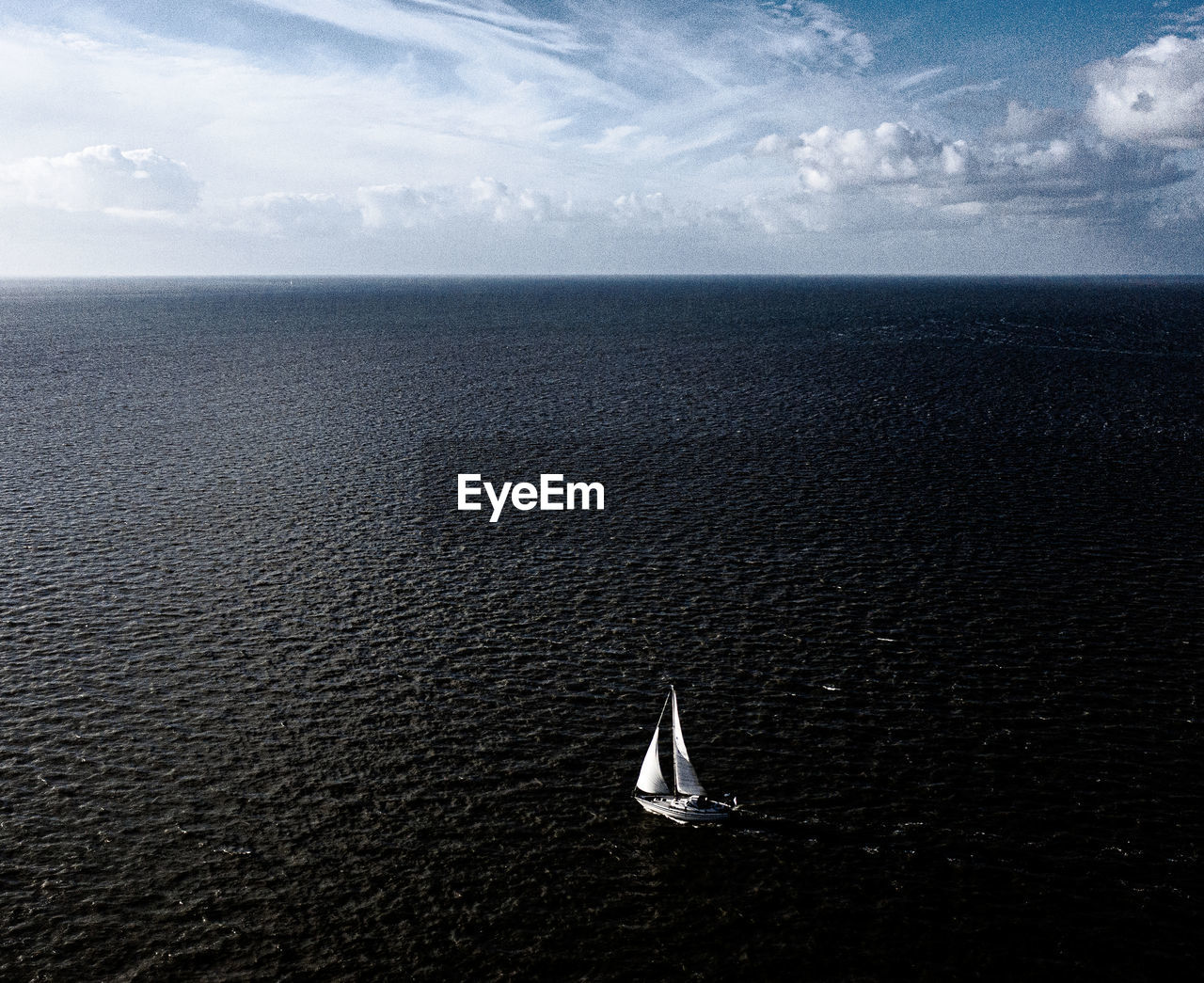 SAILBOATS IN SEA AGAINST SKY