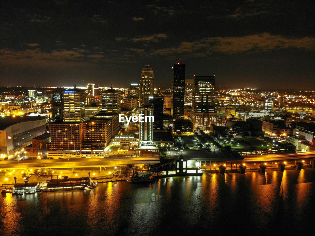 ILLUMINATED BUILDINGS IN CITY AT NIGHT