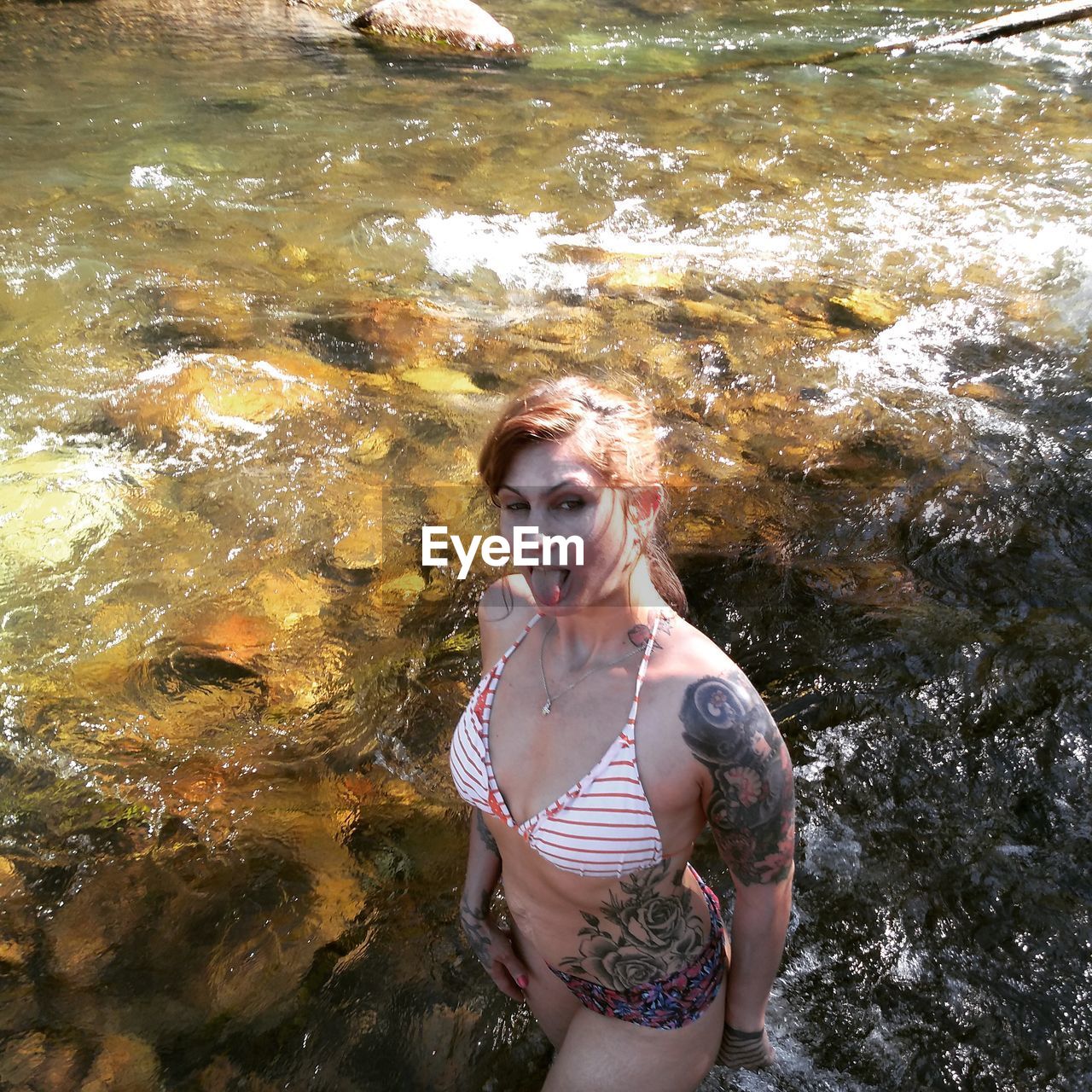 HIGH ANGLE PORTRAIT OF WOMAN STANDING IN WATER