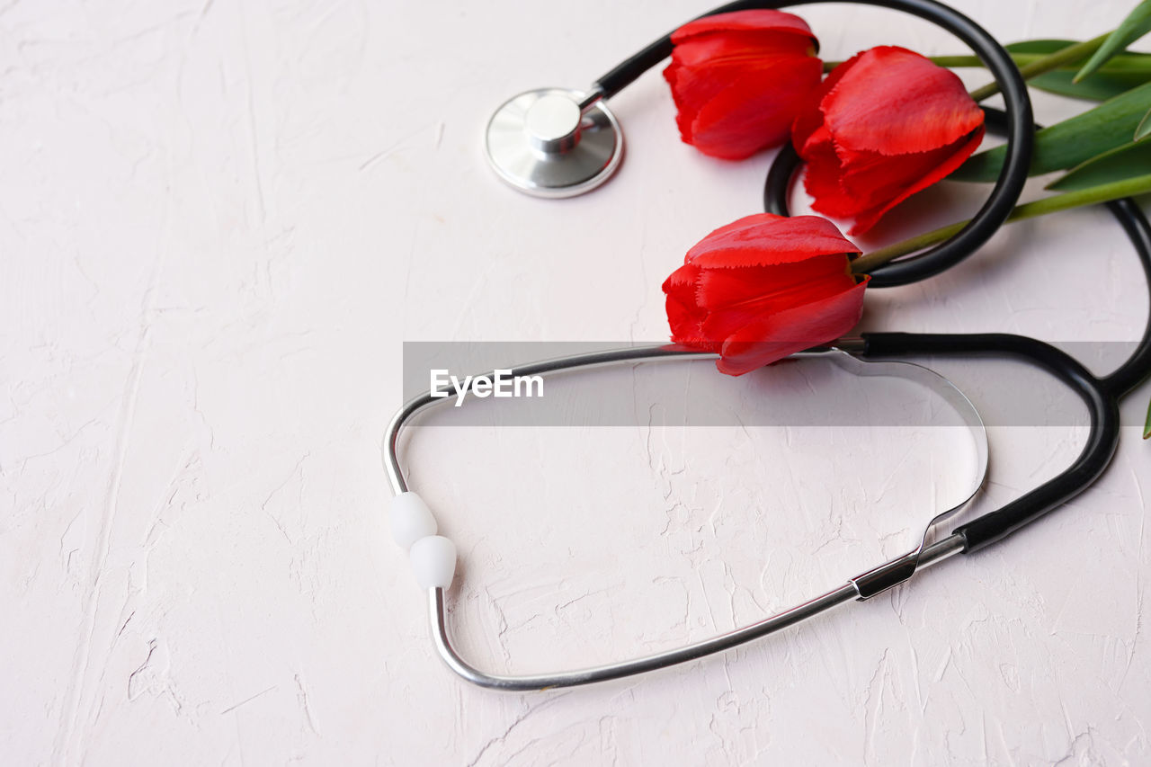 Stethoscope with flowers on white background, medicine doctor's day 