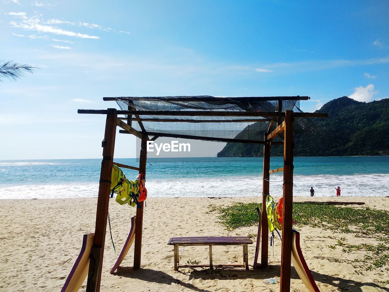 beach, water, land, sea, sky, vacation, nature, sand, scenics - nature, beauty in nature, body of water, shore, holiday, tranquility, day, sunlight, trip, horizon, tranquil scene, horizon over water, travel destinations, chair, blue, cloud, ocean, relaxation, summer, outdoors, seat, travel, wood, hut, idyllic, architecture, no people, lifeguard hut, coast, sunny