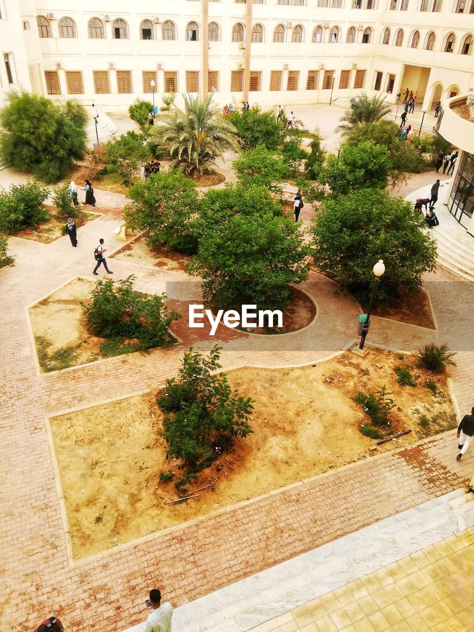 HIGH ANGLE VIEW OF PEOPLE WALKING ON STREET AGAINST BUILDINGS