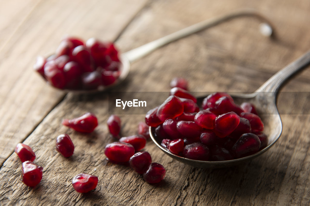 Close-up of pomegranates in spoon on table